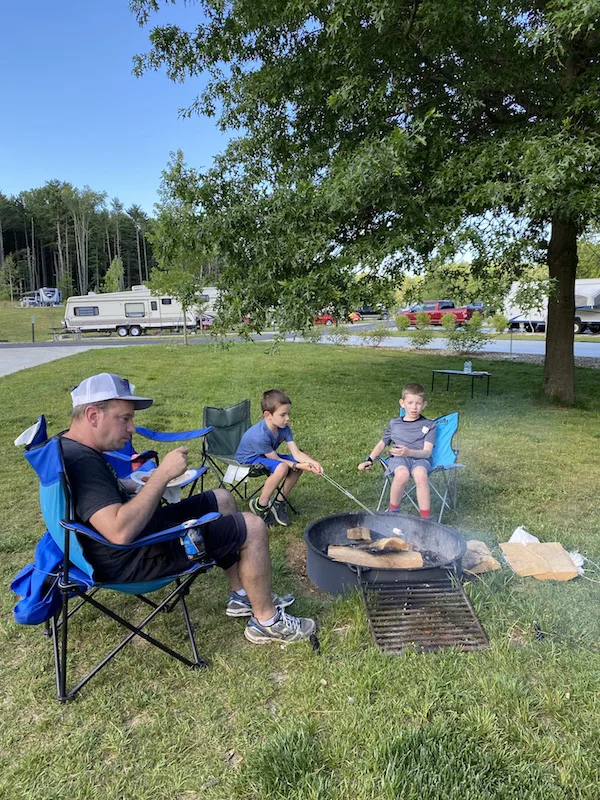 family roasting marshmallows at Pleasant Hill Lake Park.