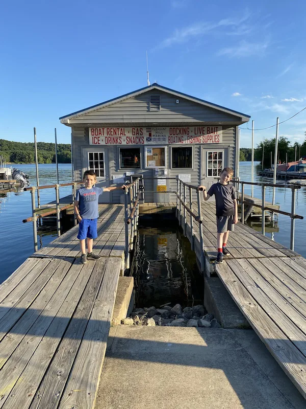Two boys standing in front of Pleasant Hill Lake Marina.