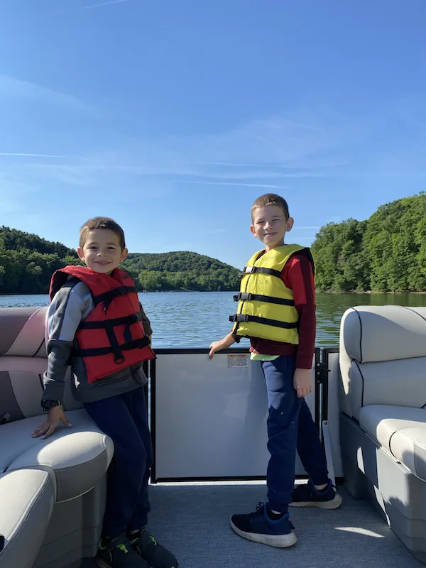 two boys on a pontoon boat at Pleasant Hill Lake.
