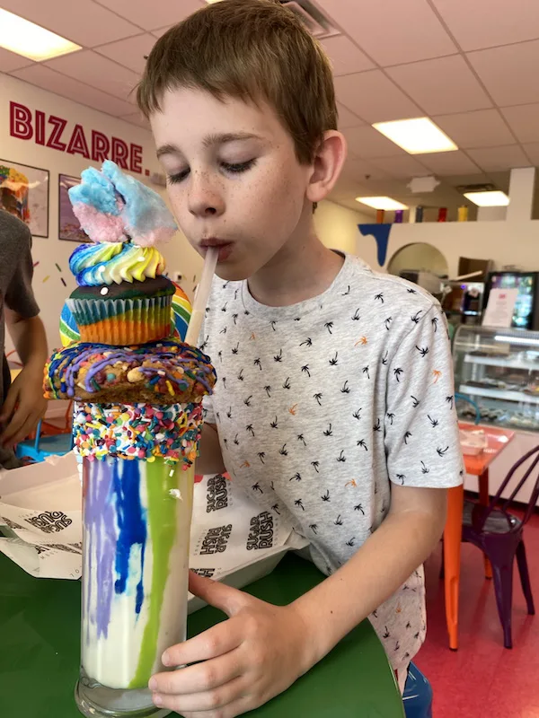 Boy drinking an extreme milkshake at Sugar Rush in Columbus, Ohio.