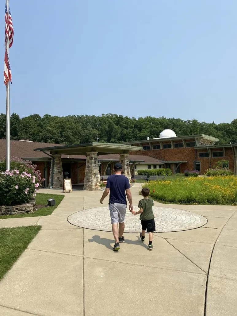 Boy and dad walking to the Environmental Learning Center at Jordan Creek Park.