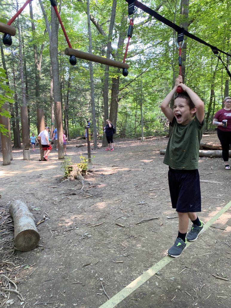 Boy on ropes course at adventure park near Cleveland, Ohio.