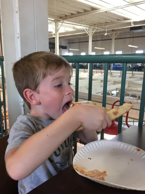 Boy eating pizza at The North Market Downtown in Columbus, Ohio.