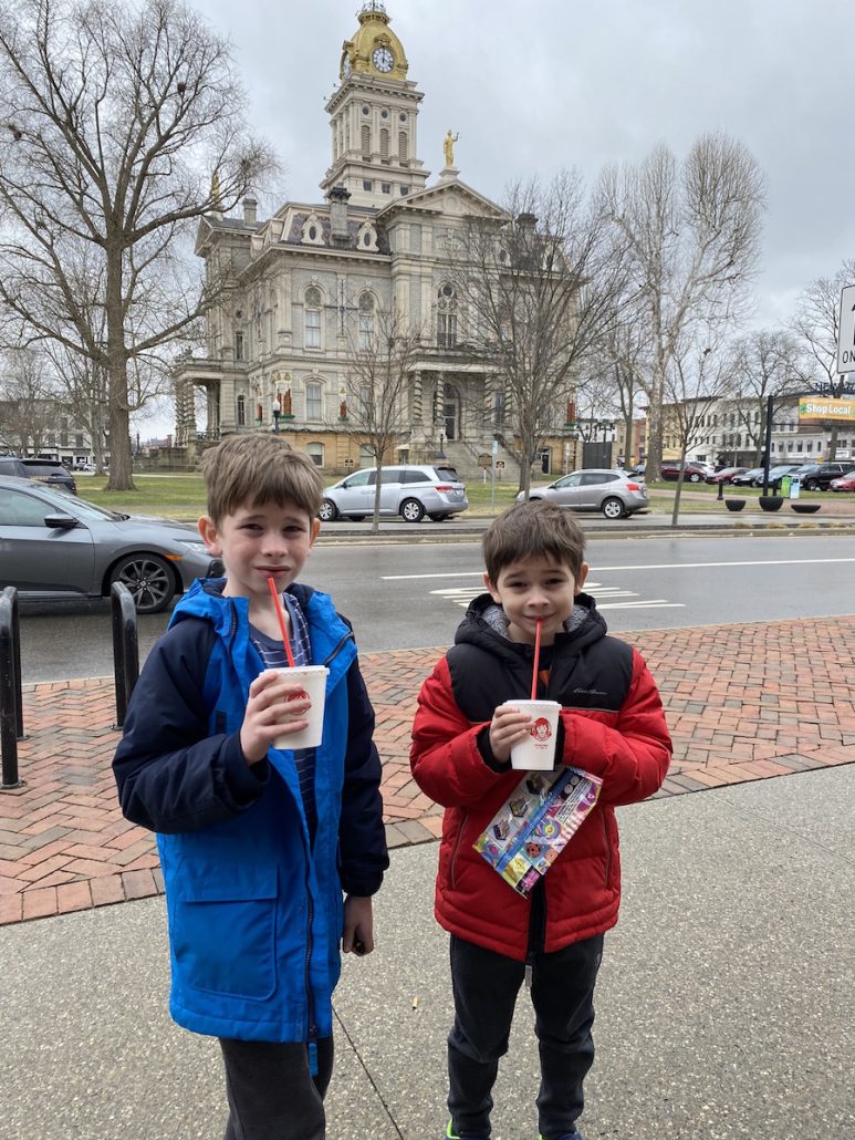 Two boys standing in front of the courthouse in Newark, Ohio.