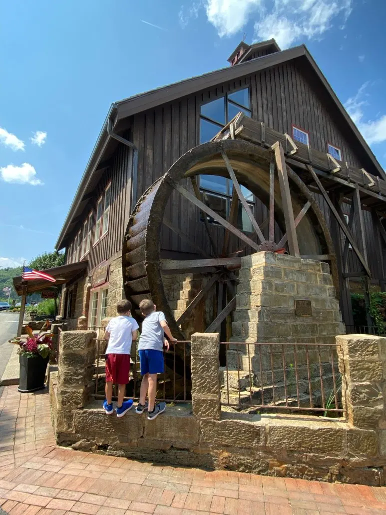 Boys watching the water mill at Ye Olde Mill in LIcking County. Things to do near Newark.
