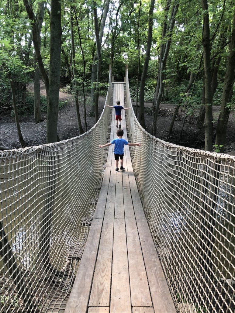 boys walking across the rope bridge at Scioto Grove Metro Park in Columbus, Ohio.