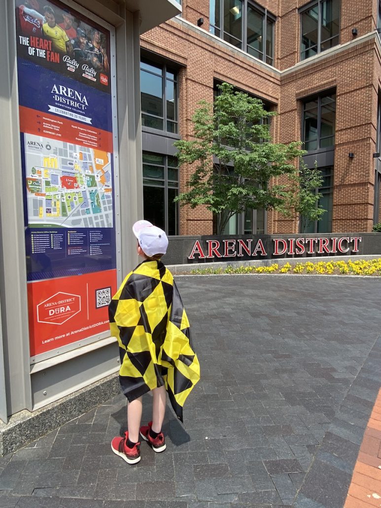 Boy reading a map in the Arena District.