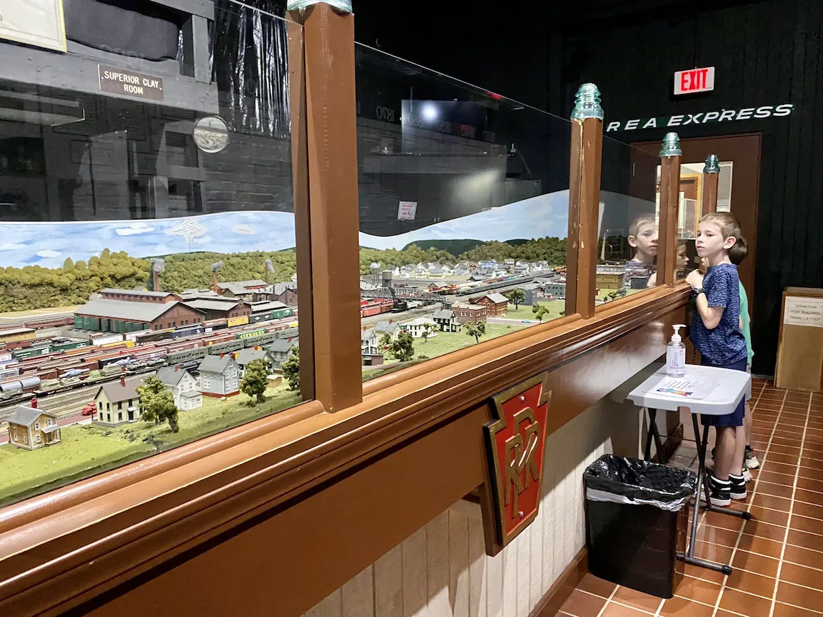 Two boys watching the model train at the Dennison Railroad Depot Museum.