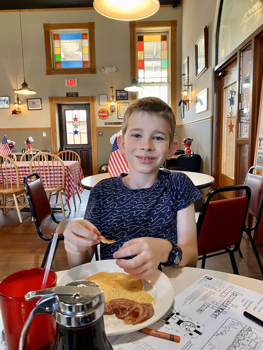 Boy eating breakfast at Over the Rail Diner in Tuscarawas, County, Ohio.