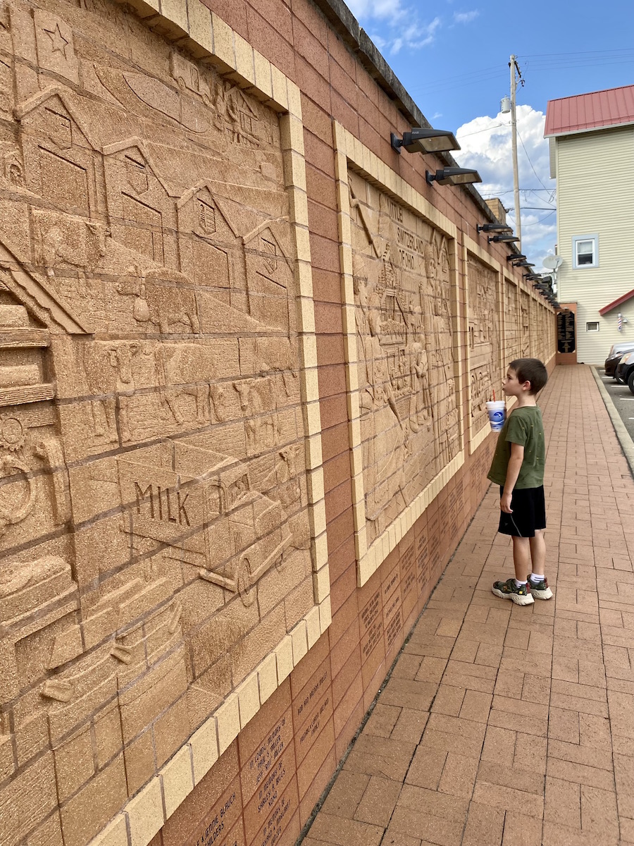 Boy looking at the murals in downtown Sugarcreek, Ohio.
