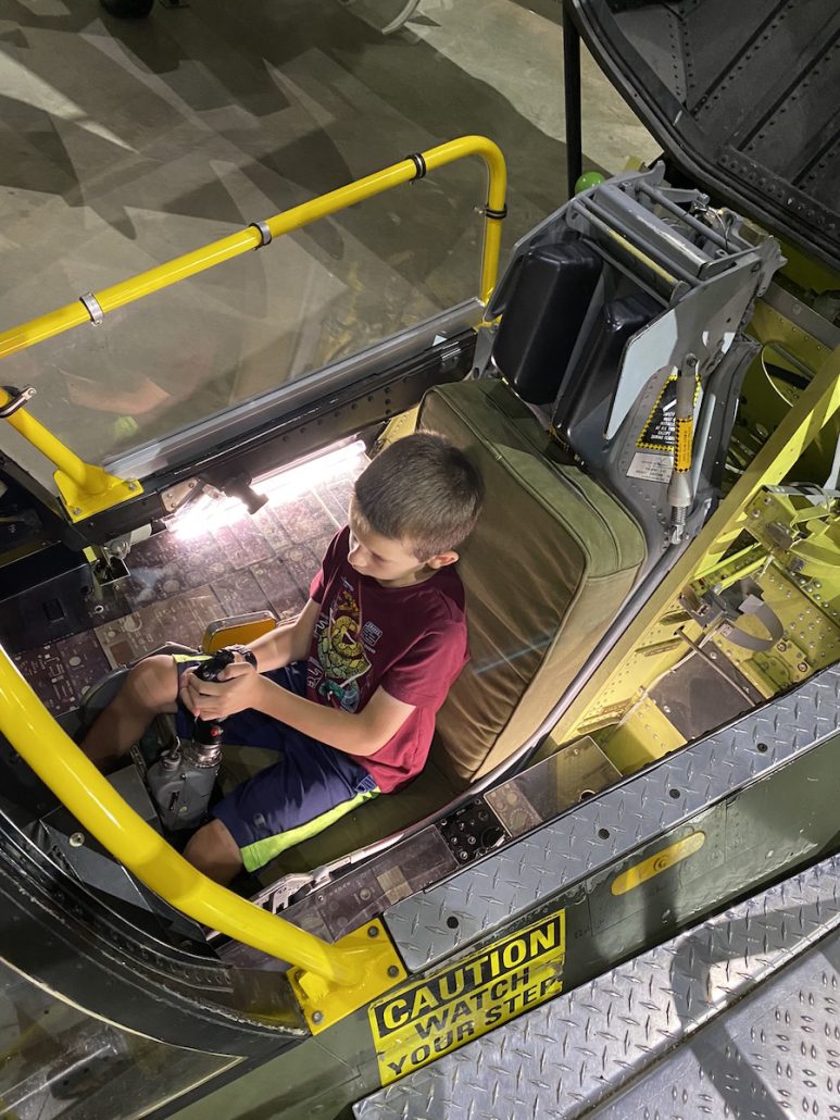 Boy inside a cockpit at the National Museum of the U.S. Air Force.