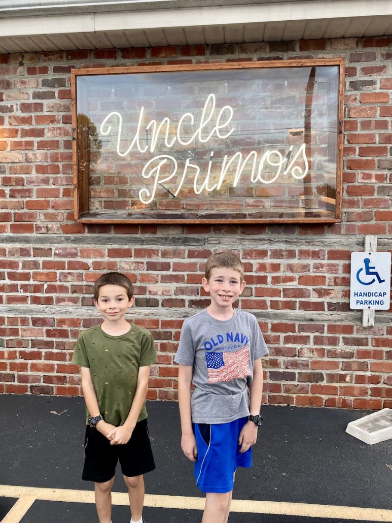 Two boys standing outside of Uncle Primo's Restaurant in New Philadelphia, Ohio.