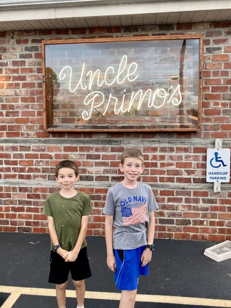 Two boys standing outside of Uncle Primo's Restaurant in New Philadelphia, Ohio.