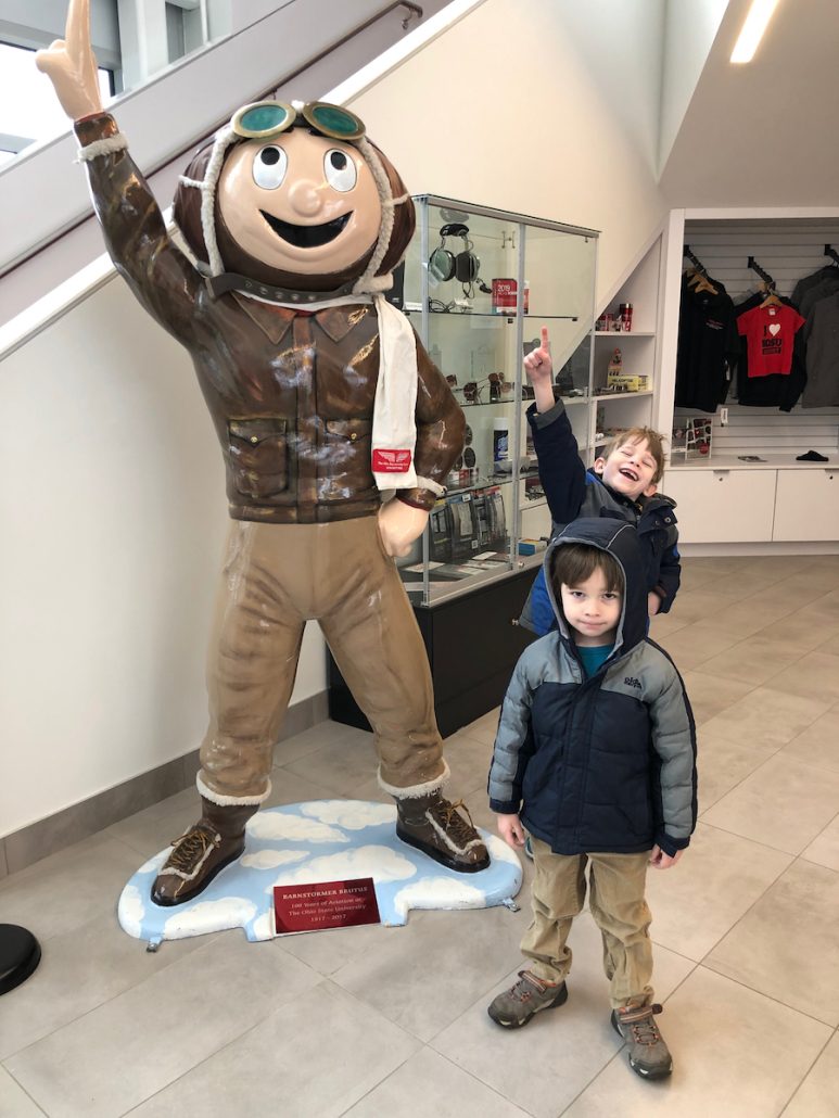 Boys taking a photo with Brutus Buckeye at the OSU airport in Columbus, Ohio.