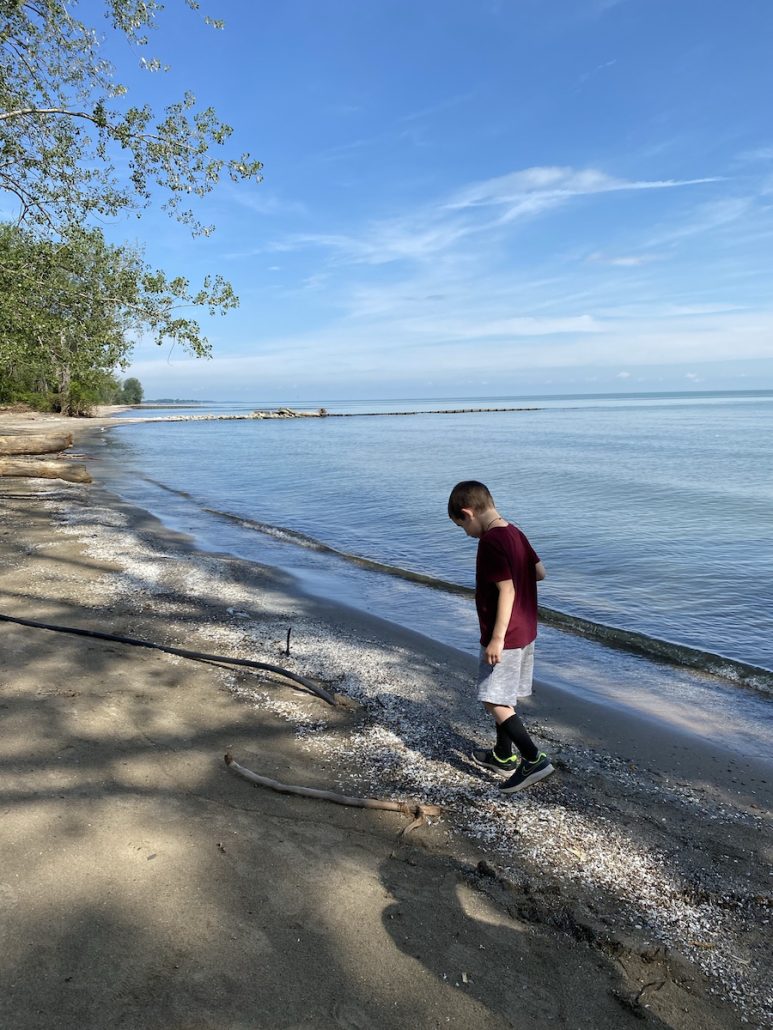 A boy walking on the beach at Magee Marsh in Toledo, Ohio.