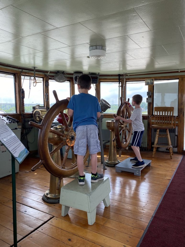 Two boys steering the ship at the National Museum of the Great Lakes in Toledo, Ohio.