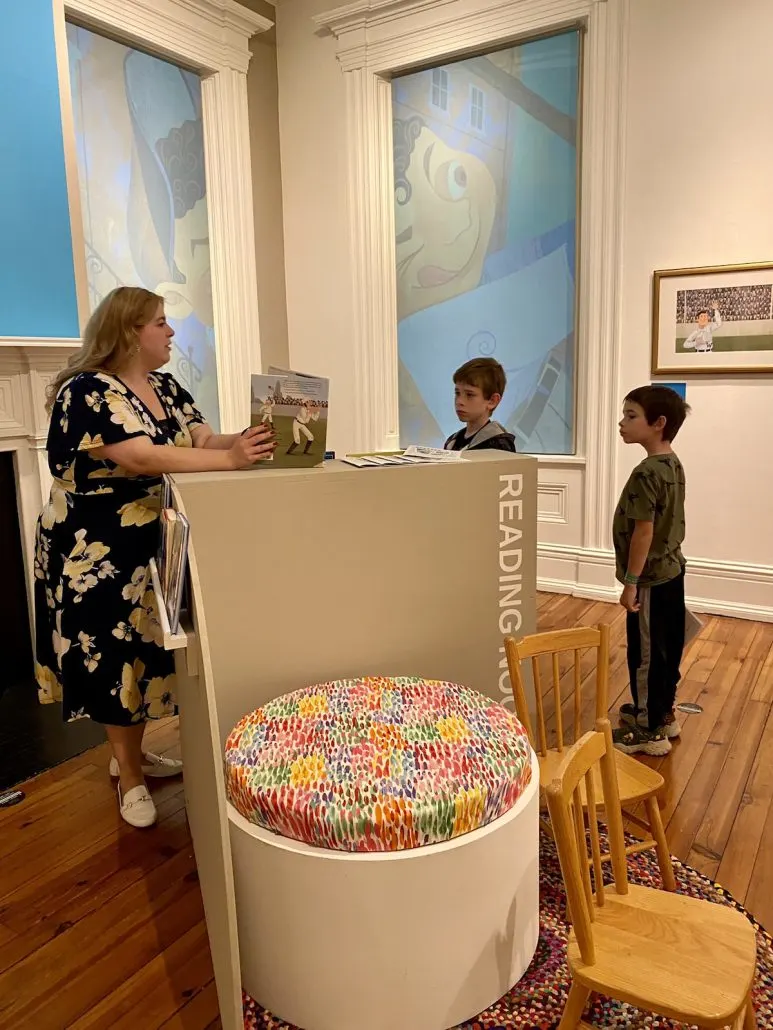 A guide telling two boys about the OHIO: The Start of it All exhibit at the Decorative Arts Center of Ohio in downtown, Lancaster.