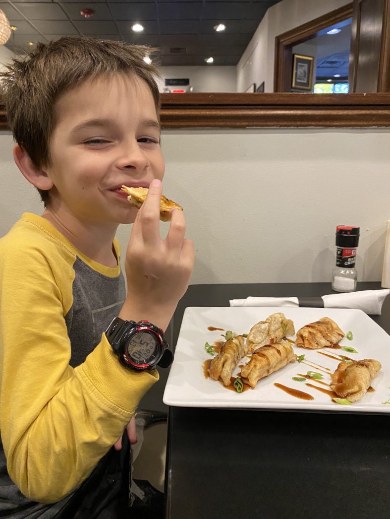 A boy eating potstickers at The Downtown Bistro, a restaurant in downtown Lancaster, Ohio.