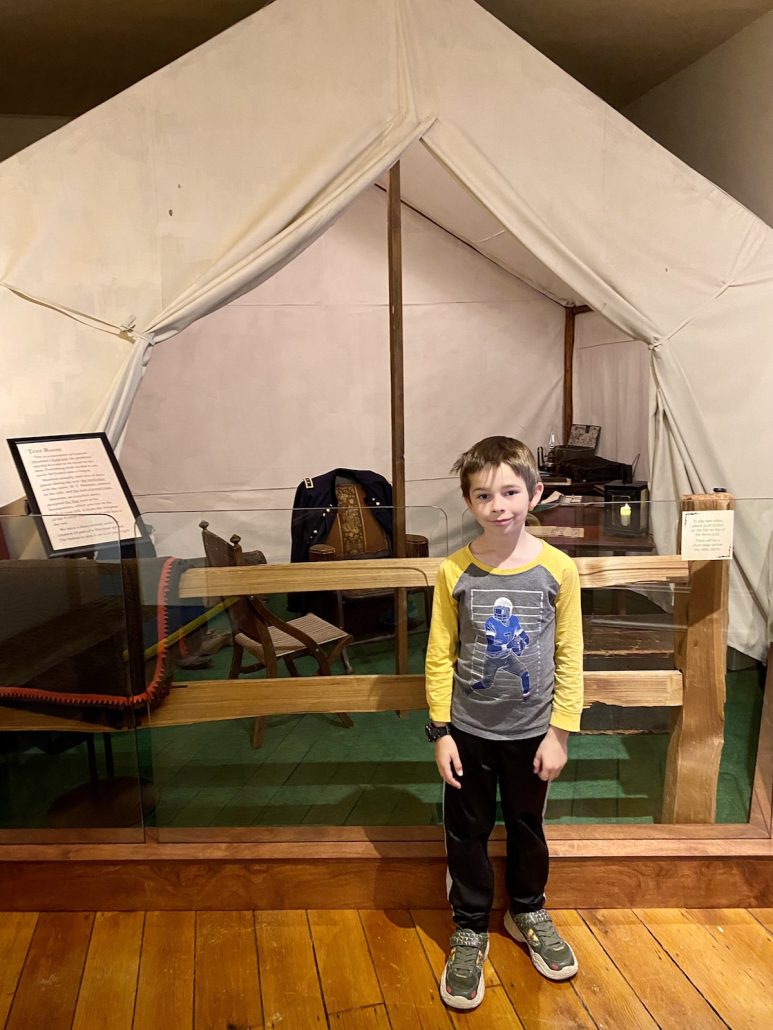 A boy standing in front of the civil war tent at the Sherman Museum in downtown Lancaster.