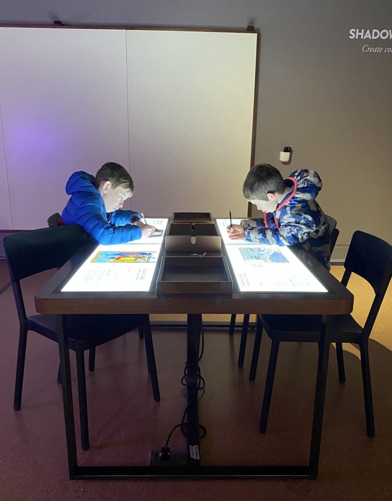Two boys drawing in the Art Sparks area for kids at the Speed Art Museum in Louisville, KY.