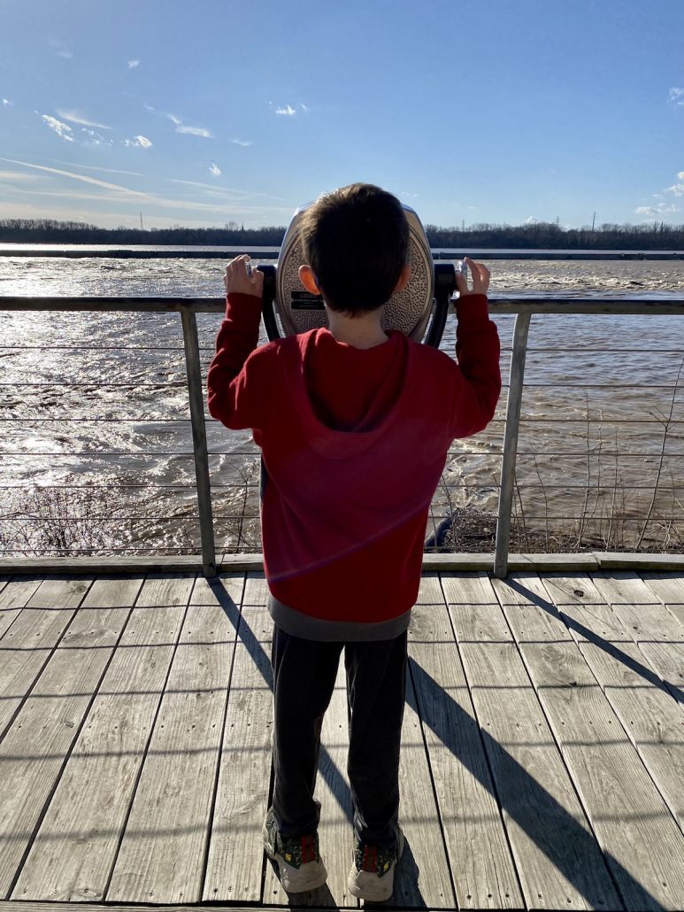 A boy looking through the viewfinder at the Falls of Ohio State Park in Indiana.