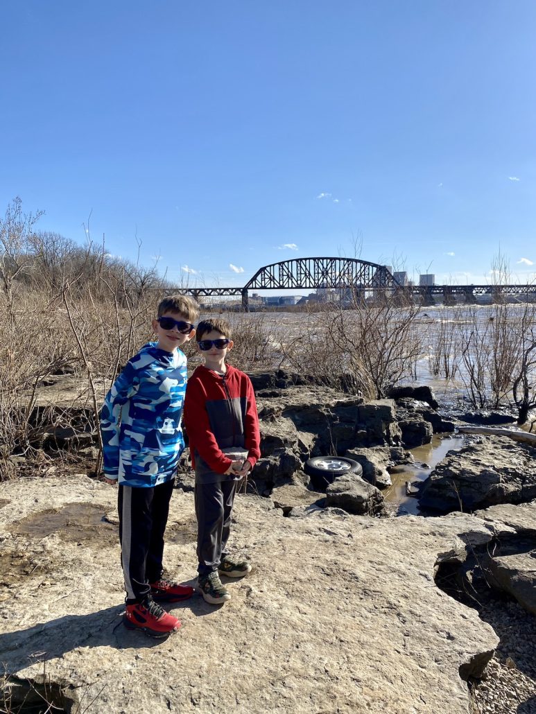 Two boys standing on the fossil beds at the Falls of Ohio State Park.