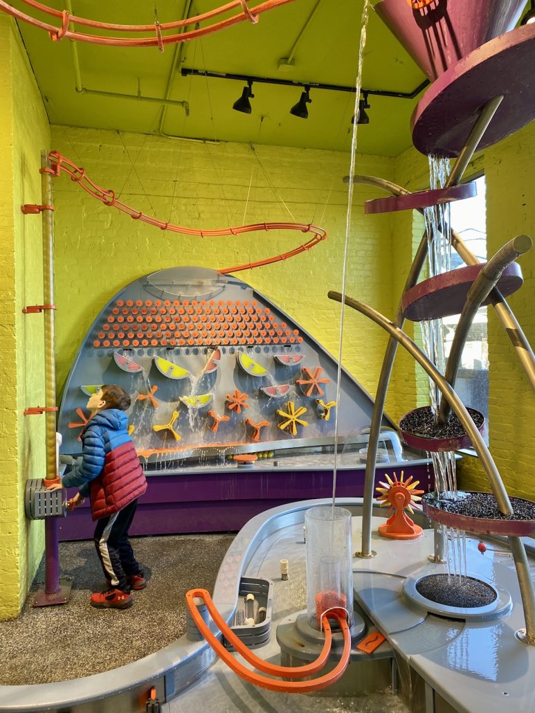A boy playing in the water science area at Kentucky Science Center.