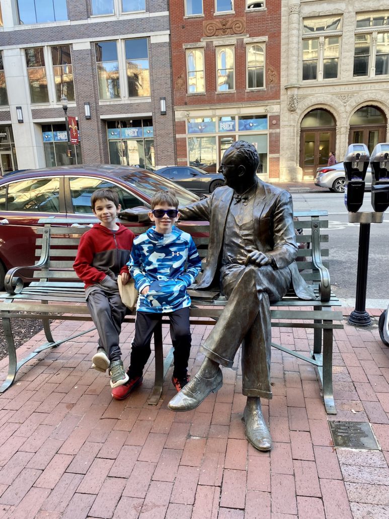 Kids sitting on a bench in Louisville, KY.