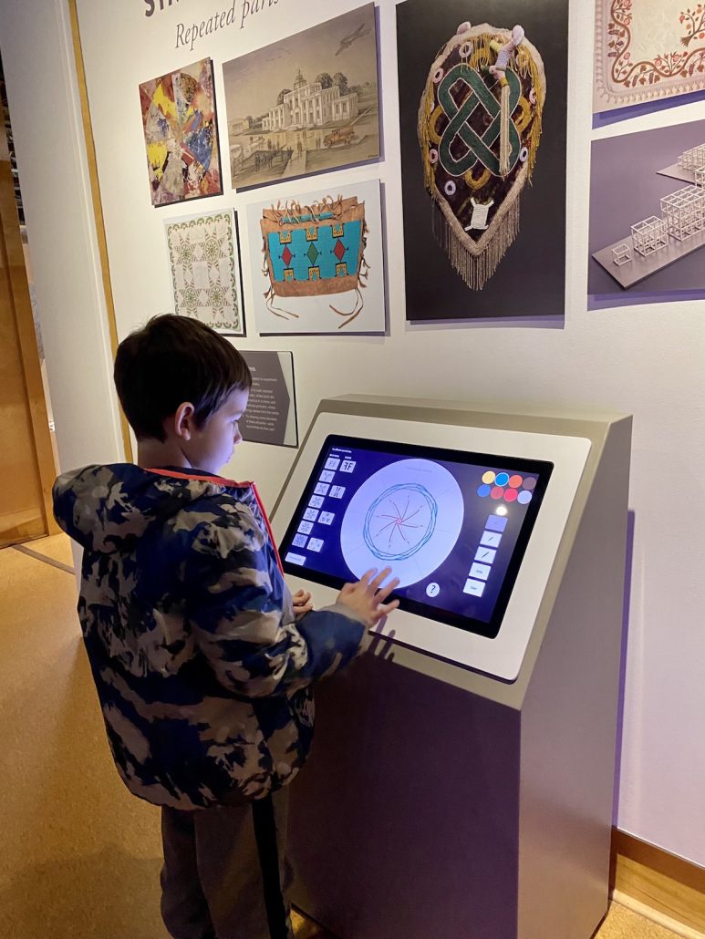 A boy drawing on a touchscreen in the Art Sparks are at Speed Art Museum.