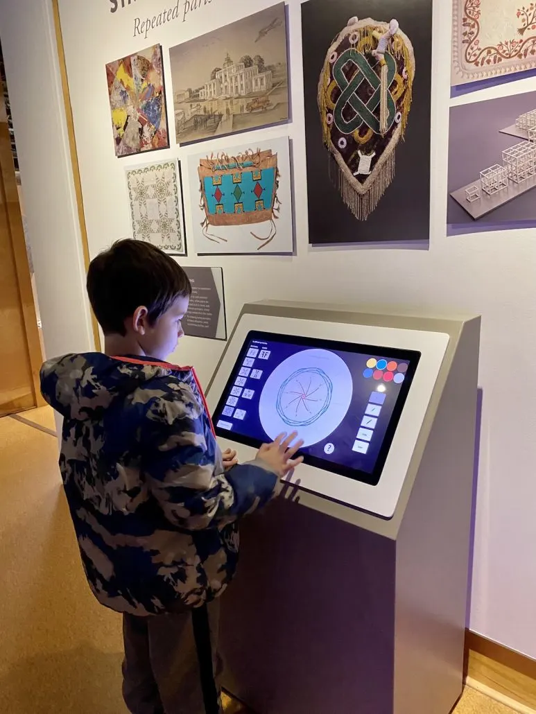A boy drawing on a touchscreen in the Art Sparks are at Speed Art Museum.