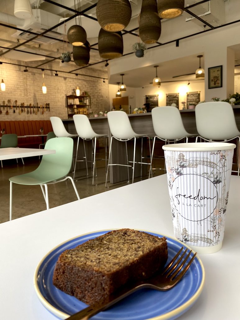 Banana bread and coffee sitting on a table at Freedom a la Cart, a coffee shop in Columbus that employs survivors of human trafficking.