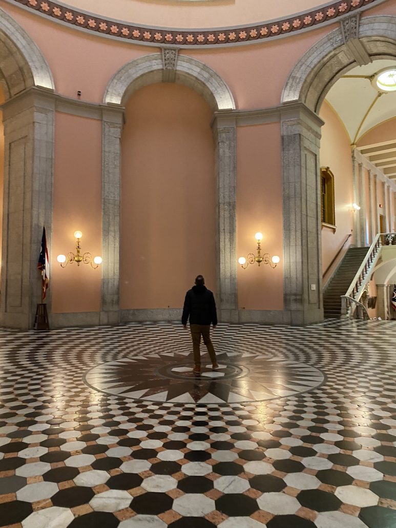 A man looking up at the rotunda at Ohio Statehouse in Columbus, Ohio.