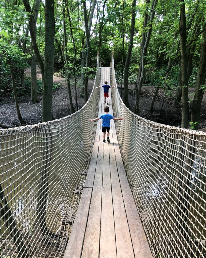Two boys on the rope bridge at Scioto Grove Metro Park, a metro park in Columbus, Ohio.