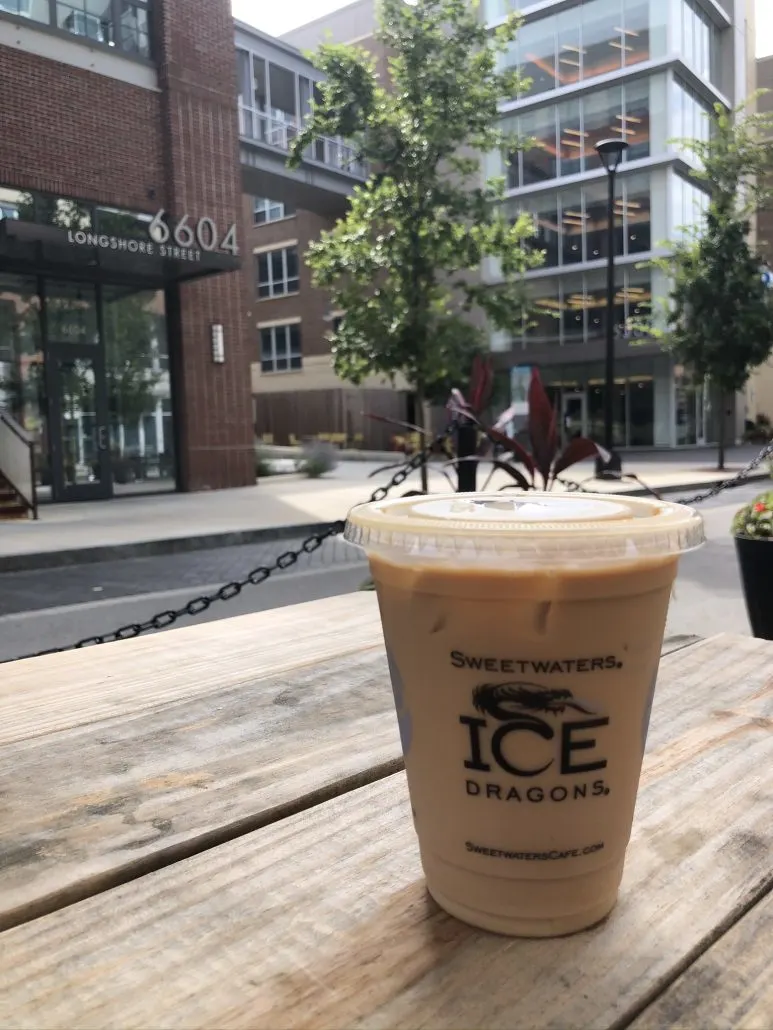 An iced coffee sitting on a picnic table in the Bridge Park district of Dublin, Ohio.