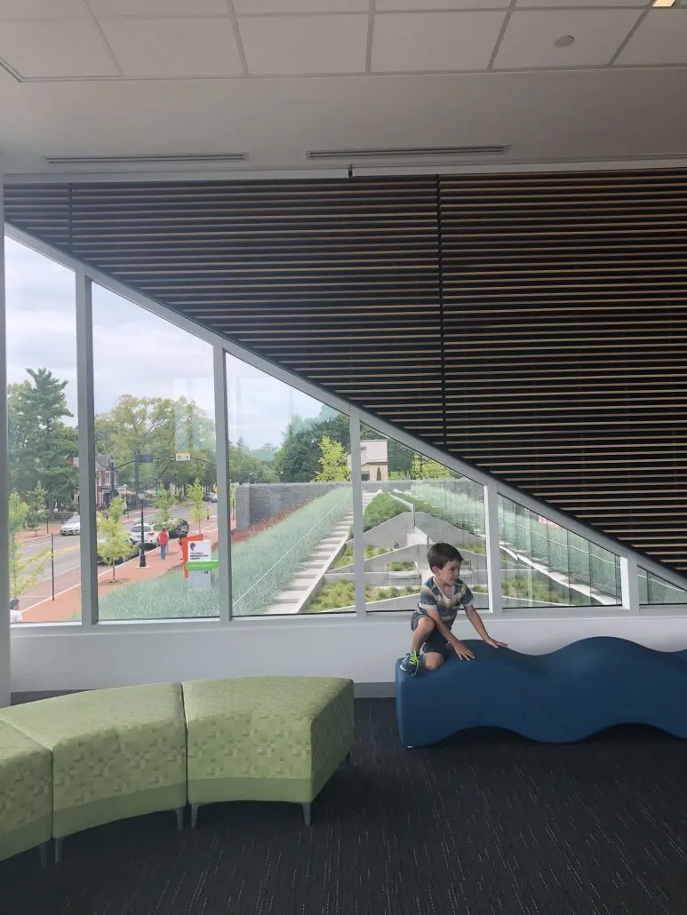 A boy on a bench inside the Dublin, Ohio branch of the Columbus Library.