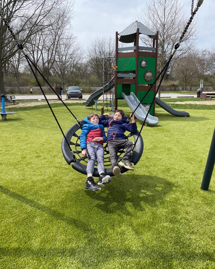 Two boys on a round swing at Perry Park in Worthington.