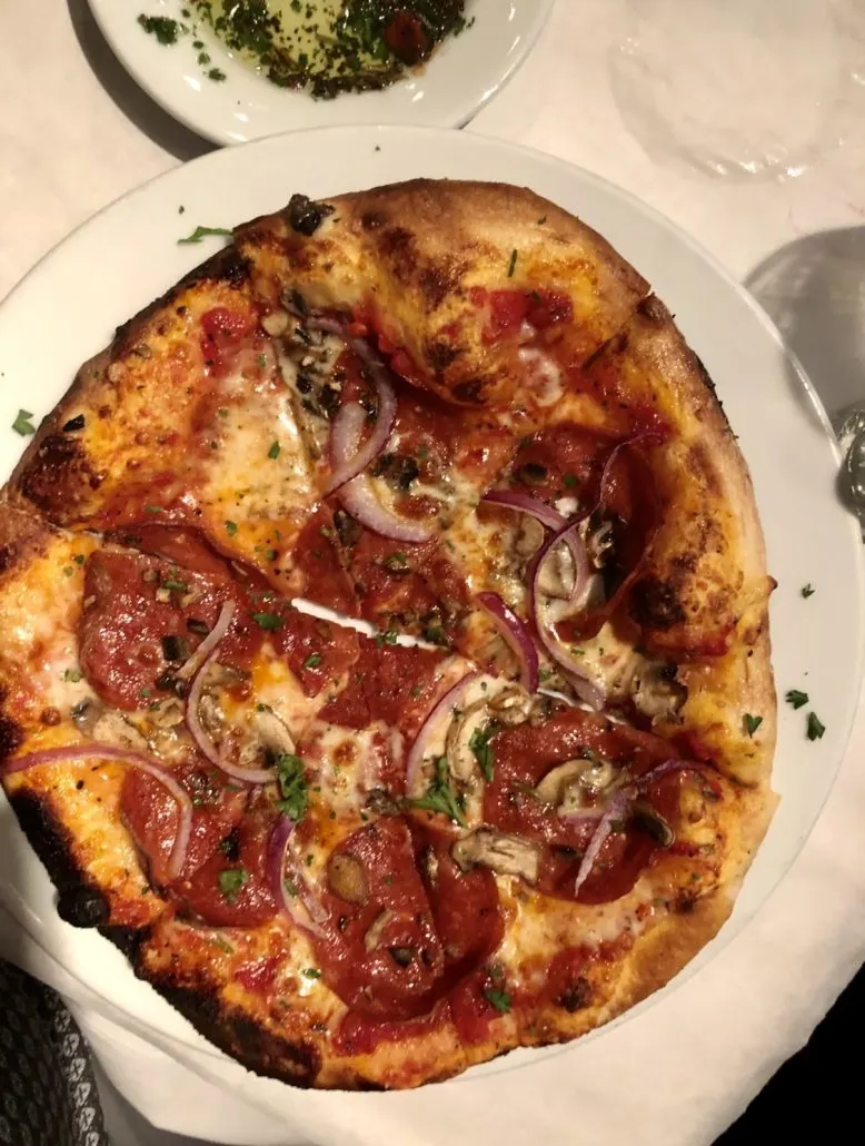 Wood-fired pizza with pepperoni and onions at Figlio, a restaurant in Grandview.