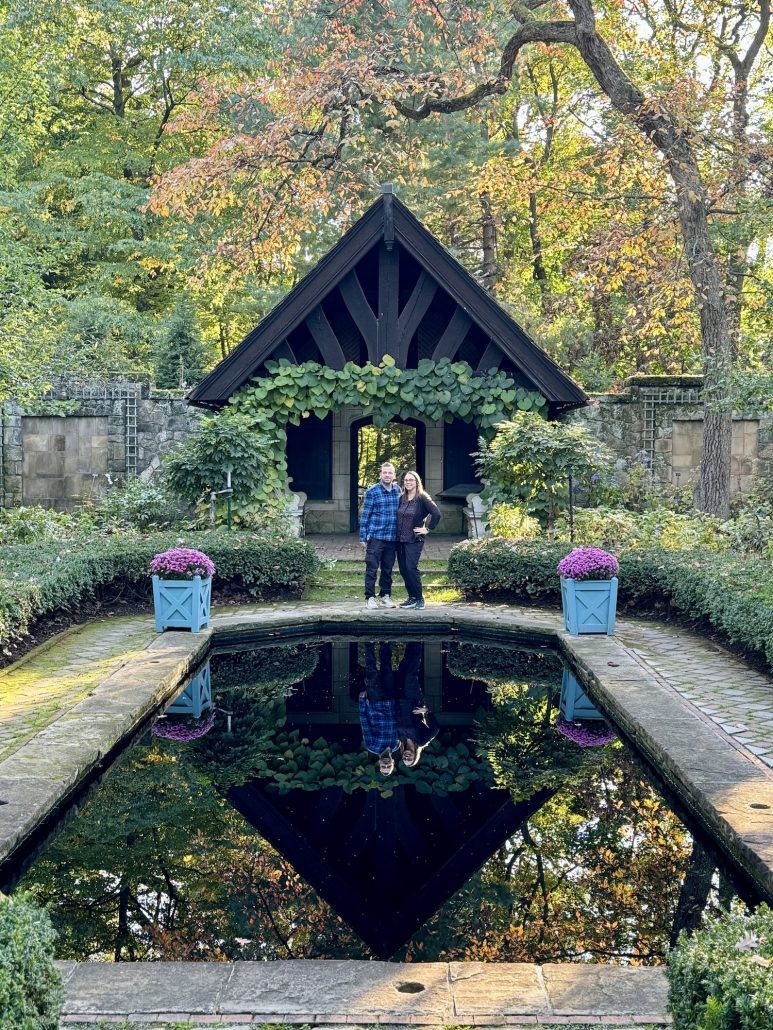 These arboretums in Ohio are some of the best places to see flowers, trees and beautiful gardens! You can also find some pretty amazing activities inside these gardens! There are some truly beautiful botanical gardens and arboretums in Ohio! If you love being out in nature and appreciate beautiful gardens, bookmark this list of Ohio's best gardens for inspiration! A man and woman next to a reflecting pool at Stan Hywet Gardens in Akron.