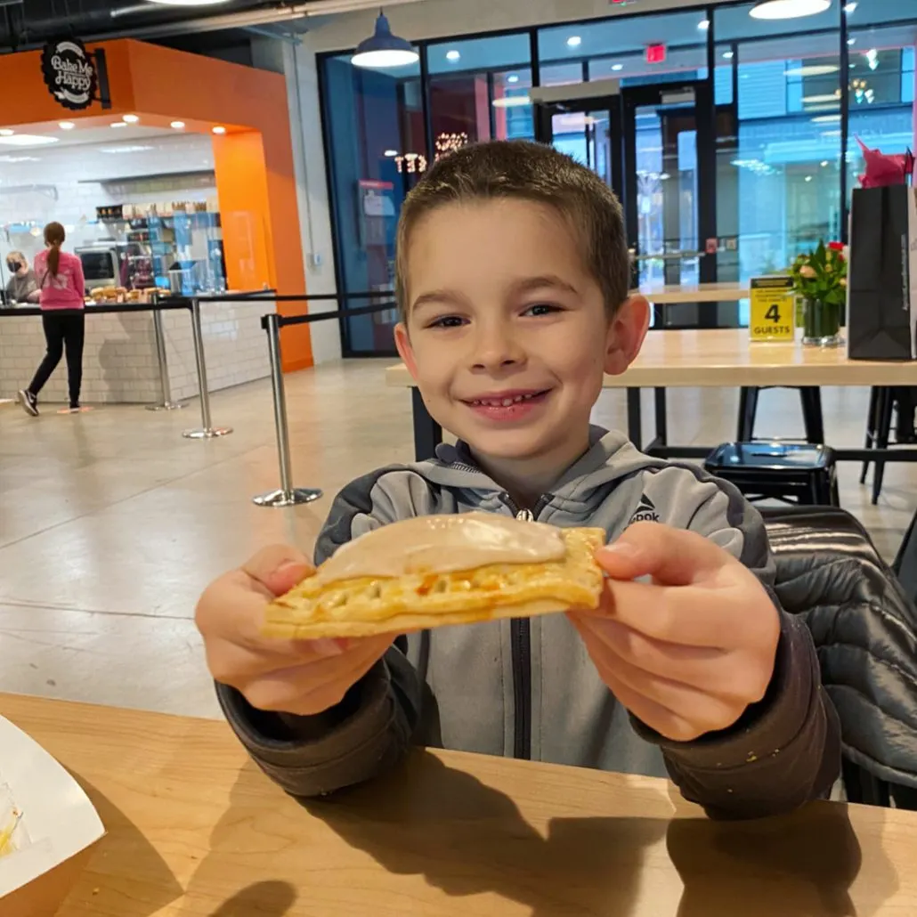 A boy holding a pop tart from Bake Me Happy in the North Market Bridge Park in Dublin, Ohio.