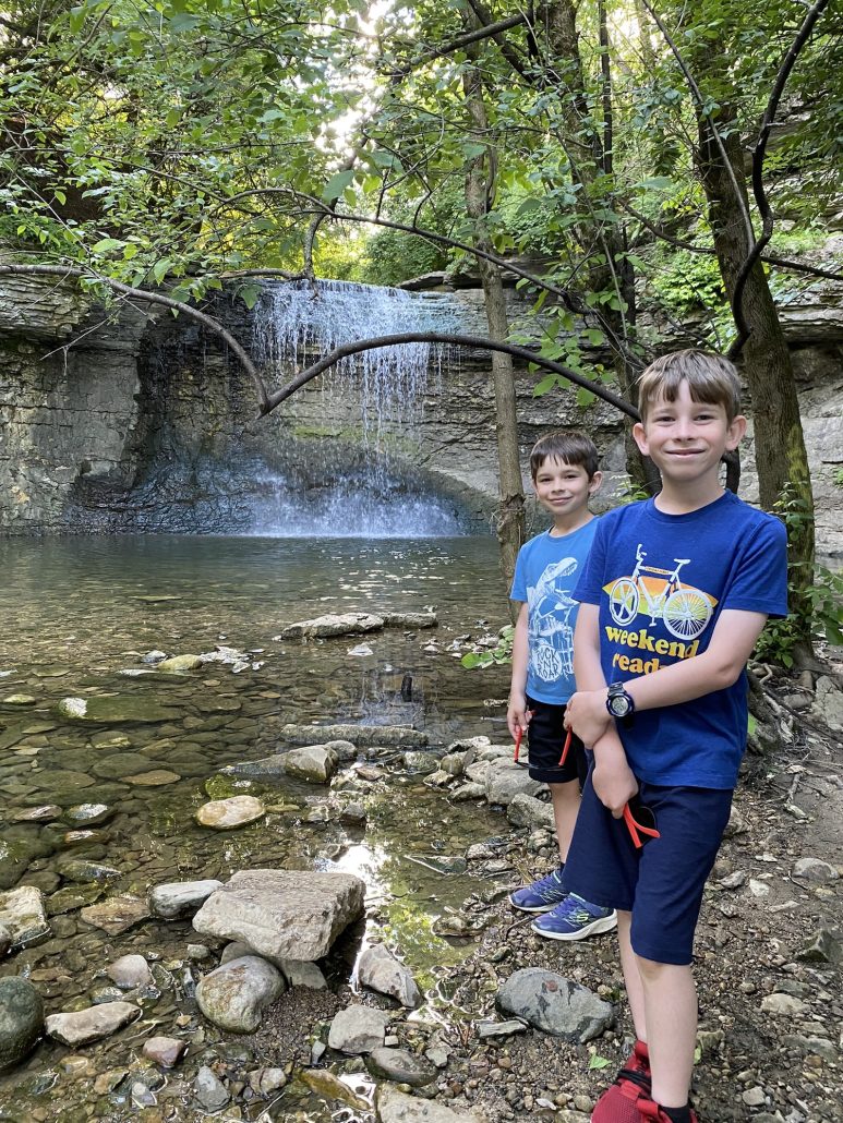 Two boys standing in front of Millikin Falls.