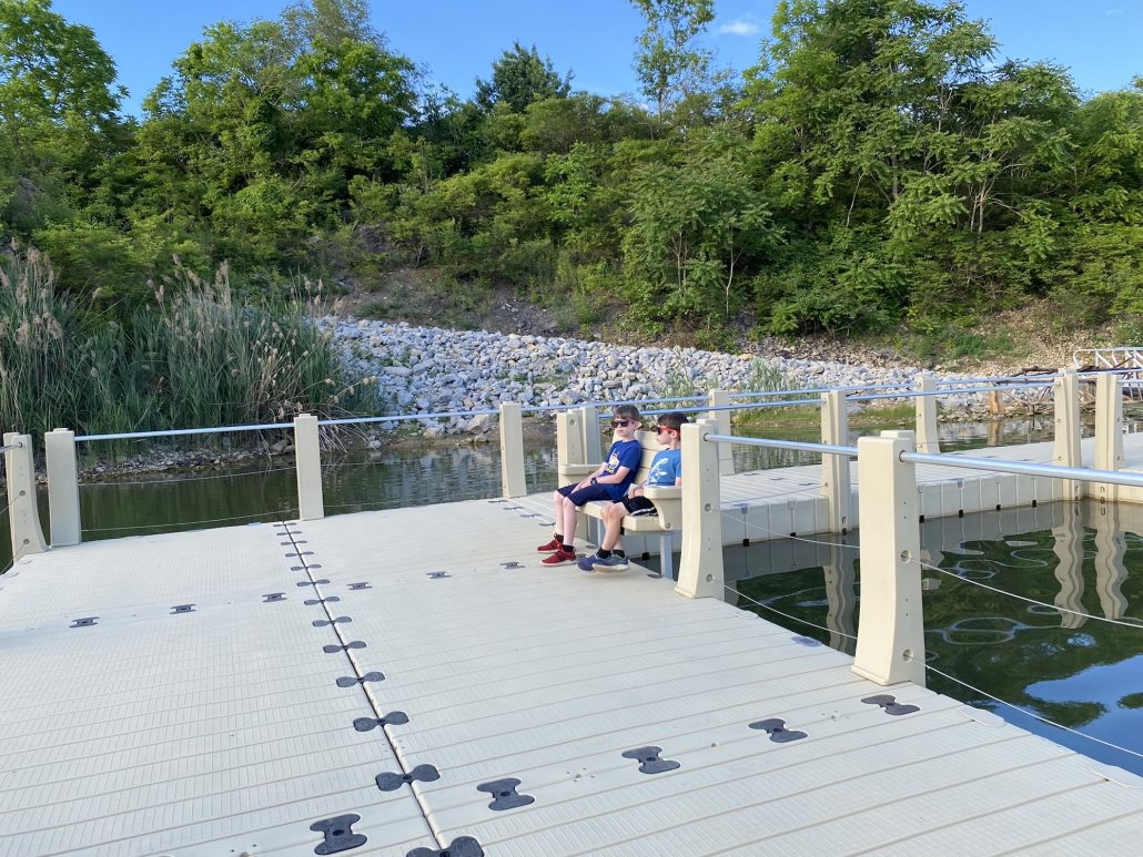 Two boys sitting on a bench on the floating boardwalk at the Metro Park.