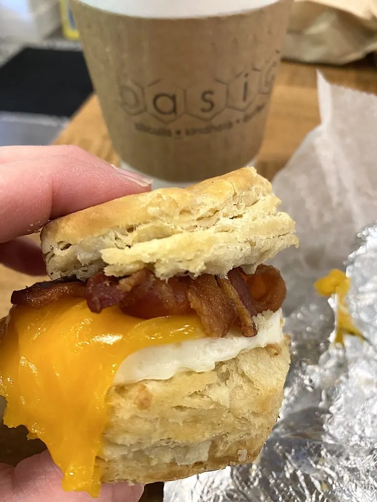 A breakfast sandwich with bacon and eggs at Basic Biscuits Kindness and Coffee, a restaurant in Grandview Heights.