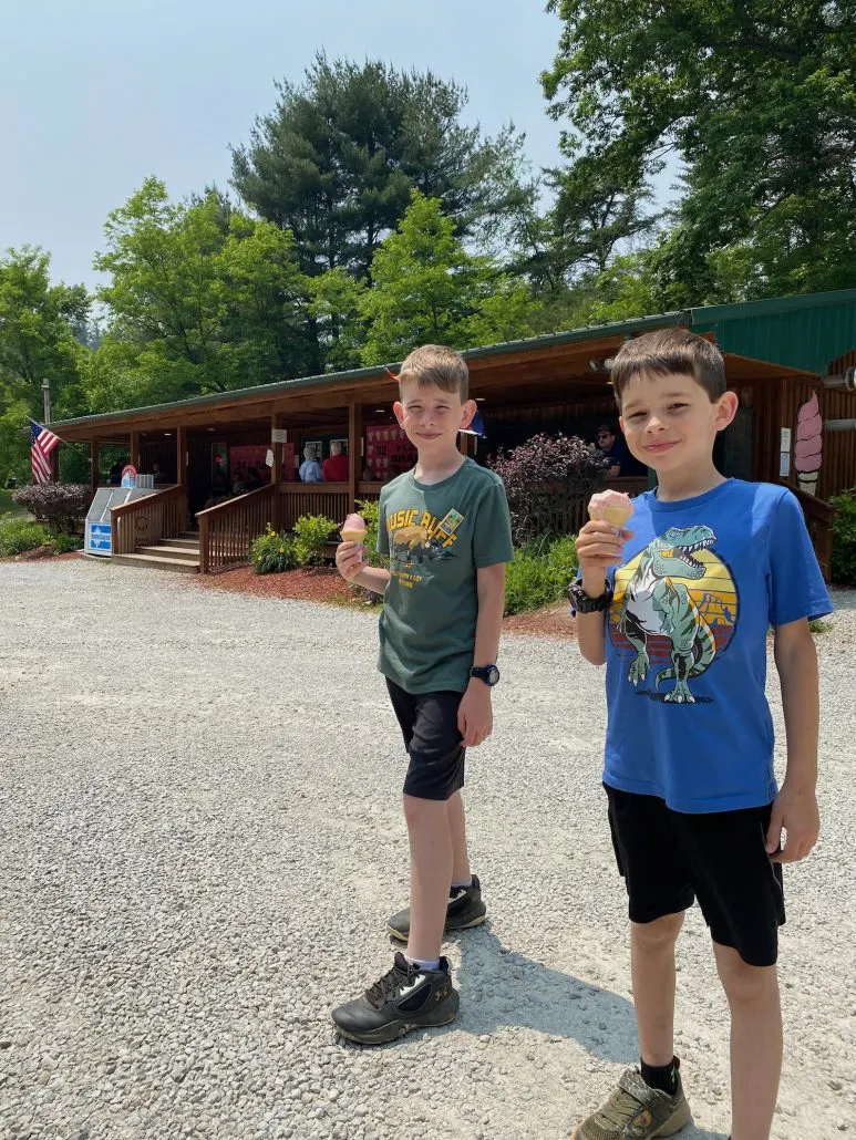 Two boys eating ice cream in front of Old Man's Cave General Store.