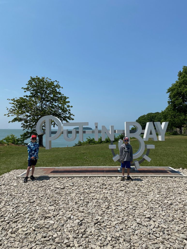 Boys in front of the Put-in-Bay sign at South Bass Island State Park.