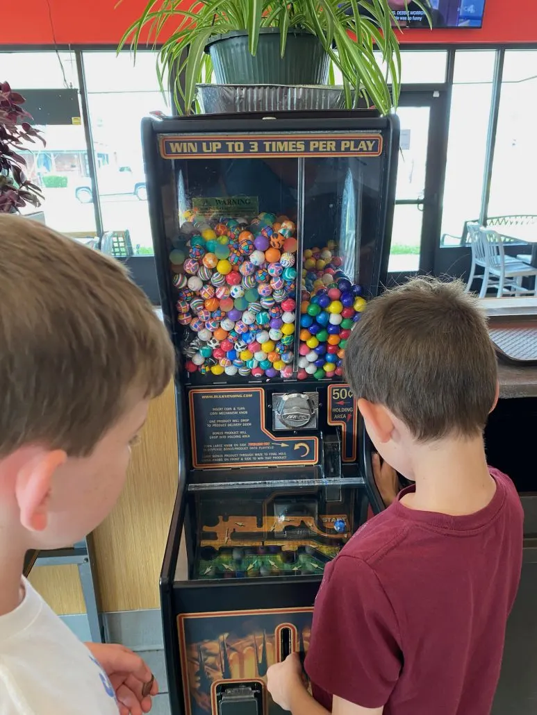 Two boys playing a gumball game at Schaffner's Drive-In in Fairfield County, Ohio.