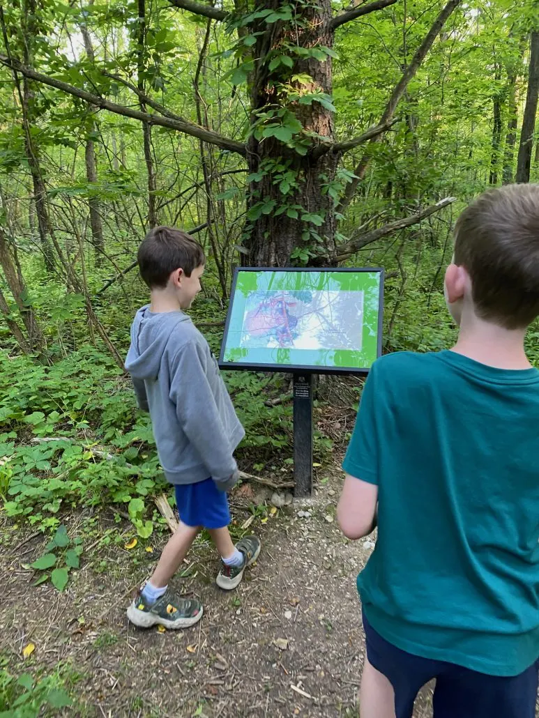 Boys walking the Story Trail at Cooper's Woods Preserve.