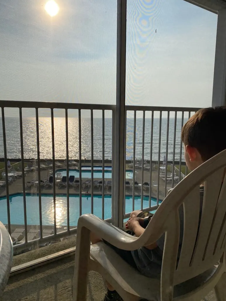 Boy sitting on the screened deck at the BayShore Resort.