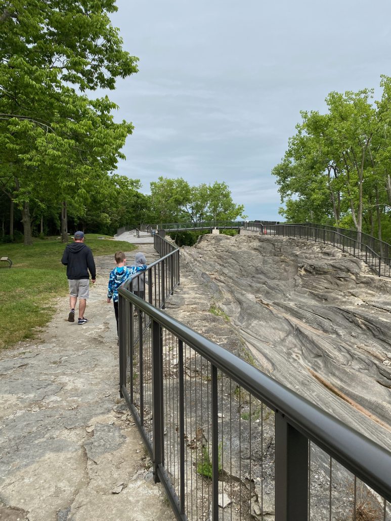Father and son walking in the Glacial Grooves Preserve in Ohio.