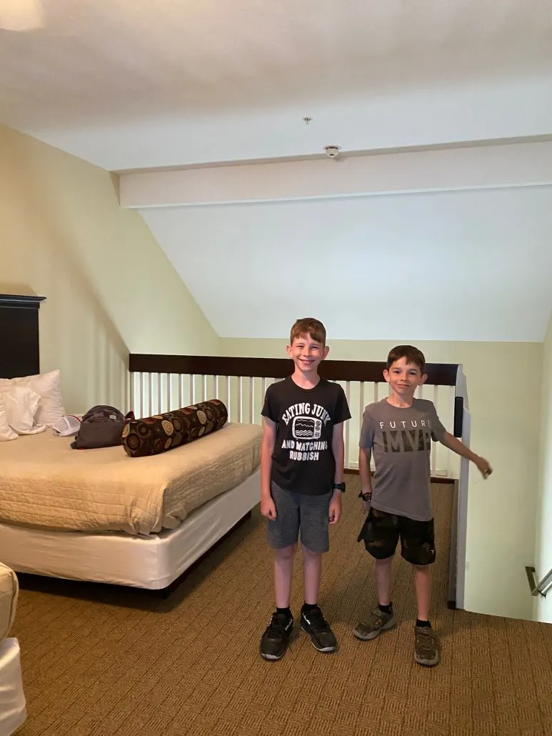 Two boys in a loft inside a hotel room at Kelleys Island Venture Resort.