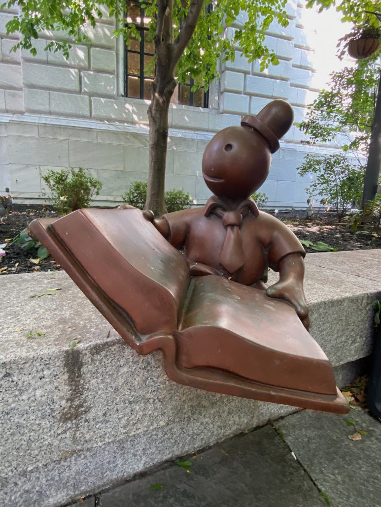 A small statue in the Eastman Reading Garden at the Cleveland Public Library.